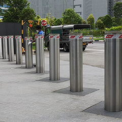 photo of automatic bollards with integrated traffic light used to make safe entry into a building with a television network