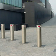 fixed stainless steel bollards positioned at the entrance of a shopping mall