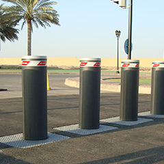 image of electromechanical bollards with integrated flashing light positioned to defend a building from any unauthorized entrances