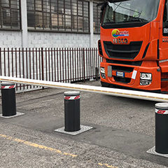 gray anthracite automatic bollards picture positioned in a transport company to prevent unauthorized access