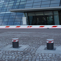 photo of anthracite gray painted automatic bollards to safeguard entry into a company