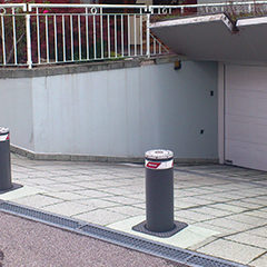 photograph of retractable bollards positioned at the entrance to a private garage as protection against possible intrusion