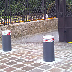 automatic bollards gray anthracite with incorporated flashing lights positioned in a bank to protect against possible robberies