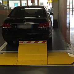 photo of Secure Parking barrier with automatic movement located in front of a parking lot to protect it from possible unauthorized parking